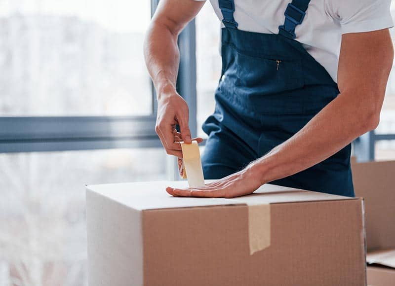 mover taping a box.